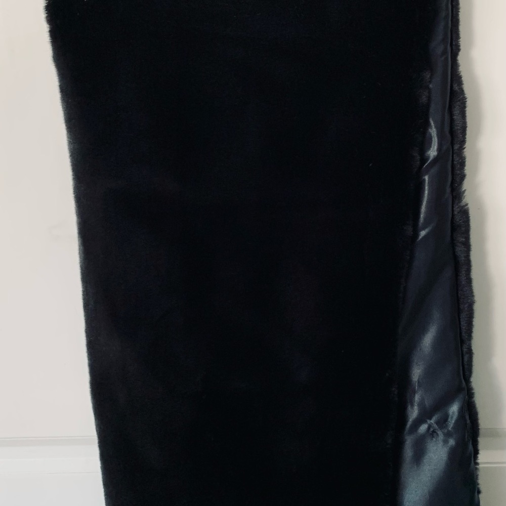 Black faux fur with Velcro closing , worn for wedding party.